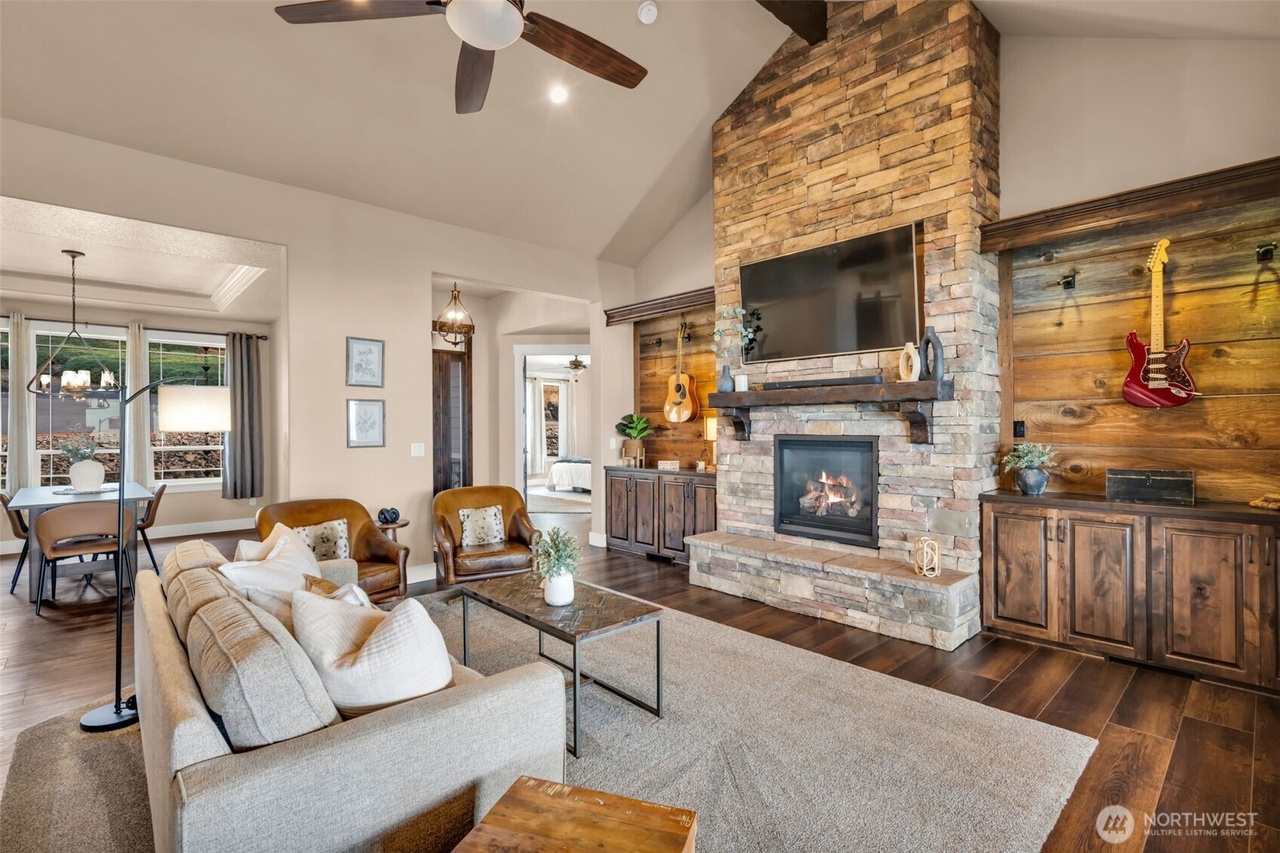 Vaulted great room with stone fireplace and river-facing windows